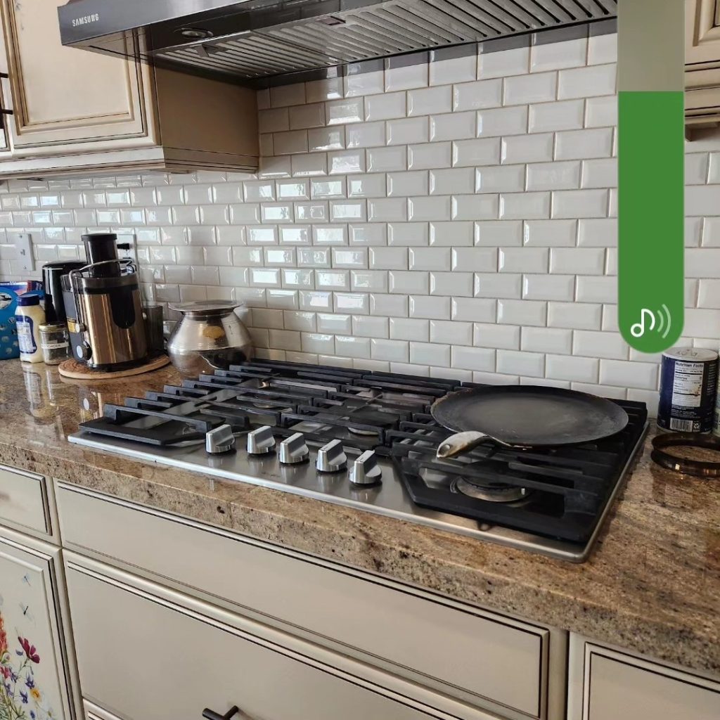 A stove top featuring a green and white sign prominently displayed on it.